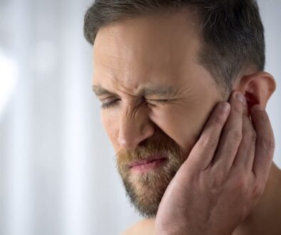 Man Holding His Aching Ear, Suffering From Otitis, Sudden Hearin