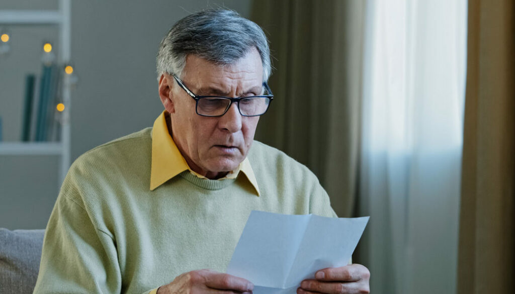 Disappointed sad upset shocked caucasian elderly male get official bank notification rejection read bad news in letter bankruptcy debt problem feel confused worried. Stressed mature man money troubled