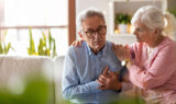 A Senior Man Holding His Chest in Pain With a Senior Woman Beside Him Comforting Him Are Aneurysms Hereditary